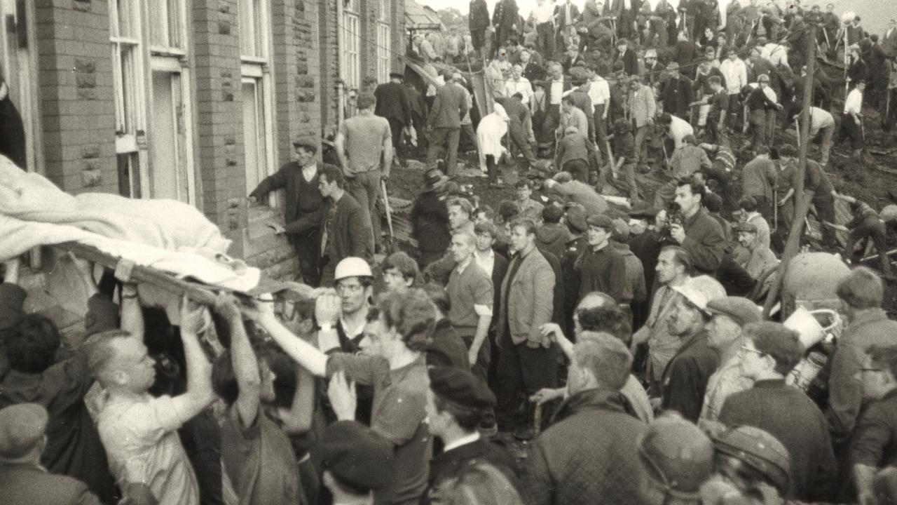 A body is taken from the local schoolhouse.