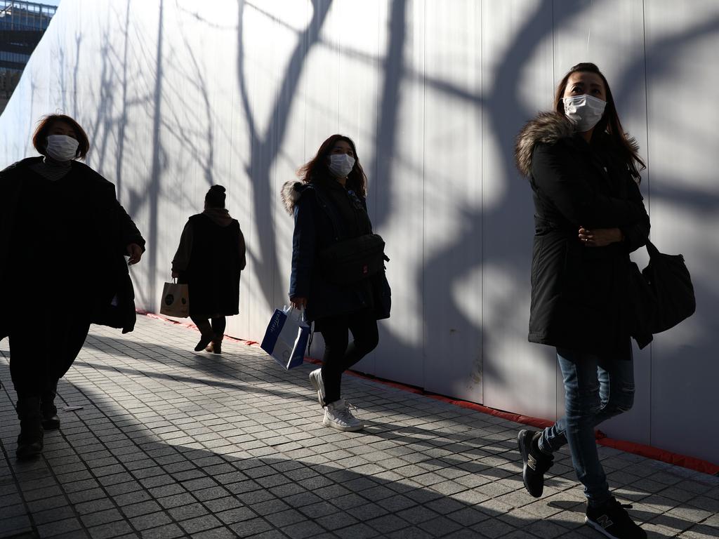 People wear masks to prevent the spread of coronavirus in Seoul’s Namdaemun market on Sunday. Picture: Chung Sung-Jun/Getty Images