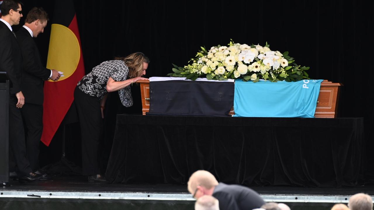 Russell Ebert's children Ben, Brett and Tammie farewell their father at Alberton Oval. Picture: Naomi Jellicoe