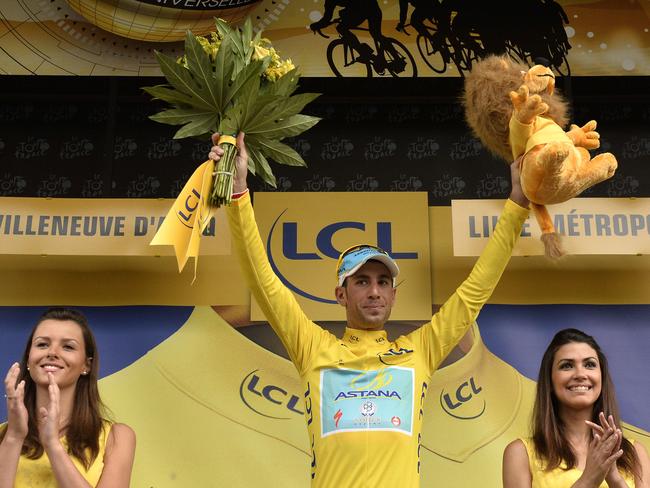 Italy's Vincenzo Nibali waves as he arrives on the podium to celebrate his overall leader yellow jersey at the end of the 163.5km fourth stage.