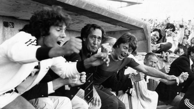 Port player Ross Agius (l), coach John Cahill and runner Ashley McKay explode in celebration from the coach's box after the final siren.