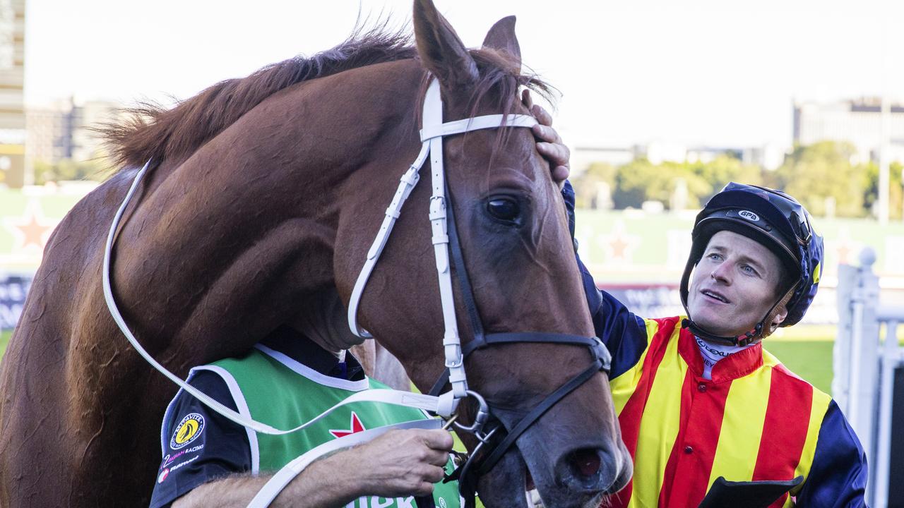 James McDonald pats Nature Strip after returning to scale. Picture: Getty Images