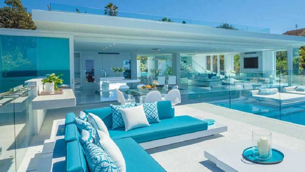 DREAM LOCATION: Glen and Deb Watson’s stunning home at Sunshine Beach has become a film set for L’Oreal and, below, the Watsons jostle for space with the crew.