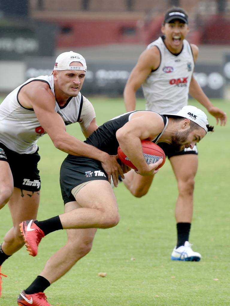 Sam Powell-Pepper tackles Sam Gray at Port Adelaide training at Alberton on Wednesday. Picture: Naomi Jellicoe