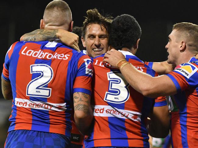 Knights Mitchell Pearce celebrates a try with teammates during the Round 2 NRL match between the Canberra Raiders and the Newcastle Knights at GIO Stadium in Canberra, Sunday, March 18, 2018. (AAP Image/Mick Tsikas) NO ARCHIVING, EDITORIAL USE ONLY