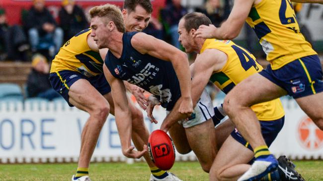 South Adelaide’s Jason Horne is stripped of the ball against the Eagles at Woodville Oval on Saturday. Picture: Brenton Edwards