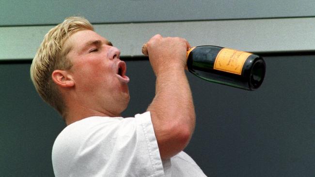 Shane Warne swigs champagne after Australia’s 1997 Ashes victory. Cricket P/R Picture: Phil Brown