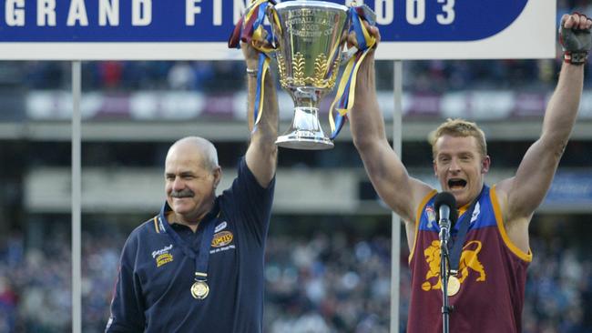 Leigh Matthews and Michael Voss hold the Premiership Cup aloft in 20023