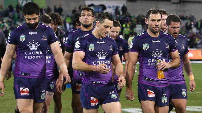 Cooper Cronk and Cameron Smith lead dejected Storm players off the field. Picture: Kym Smith