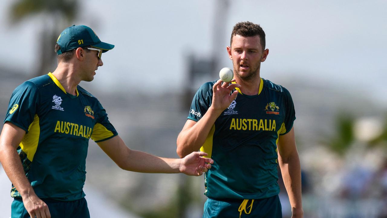 Australia's Josh Hazlewood (R) and teammate Pat Cummins during the ICC men's Twenty20 World Cup 2024 group B cricket match between Australia and England. (Photo by Randy Brooks / AFP)