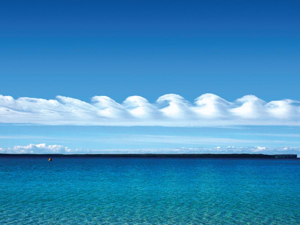 November: Kelvin-Helmholtz wave cloud over Jervis Bay, New South Wales. Photograph: Giselle Goloy. The wave-shaped clouds in Giselle Goloy’s photograph are a result of Kelvin-Helmholtz instability. Lighter, warmer air lying over denser, colder air forms two separate layers, and different wind speeds in each layer cause rippling at the boundary. The effect is similar to a flag flapping, caused by differences in wind speed on either side of the cloth.