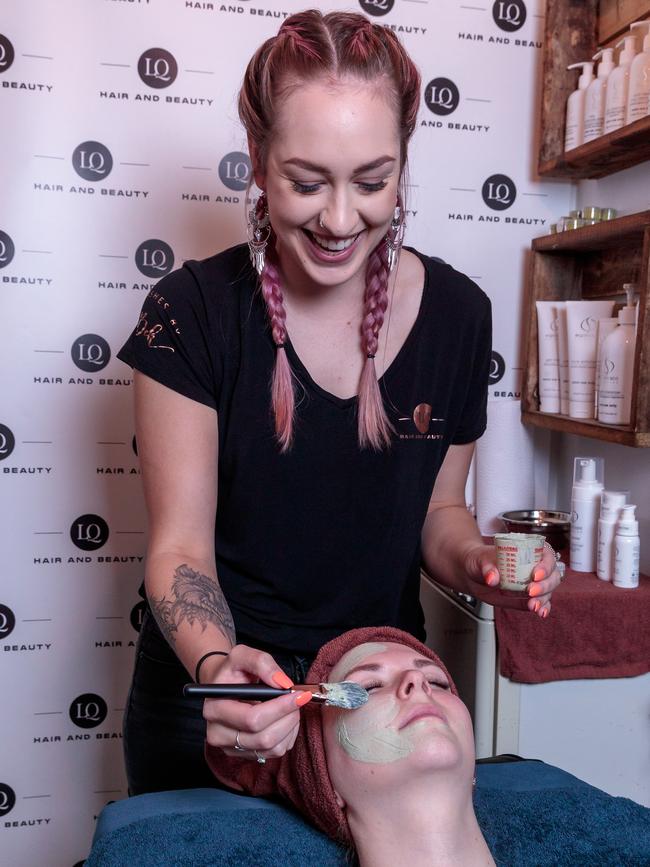 Therapist Bek gives a customer a facial. Picture: Mark Dadswell