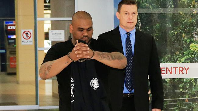 Sandeep Dharan escorted by police through the Cairns Airport.