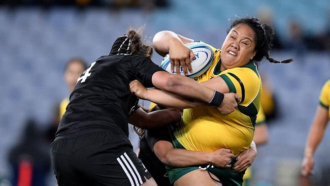 Leilani Perese of the Wallaroos is tackled by Eloise Blackwell of the Black Ferns during the Women's International rugby match between Australia and New Zealand at ANZ Stadium.