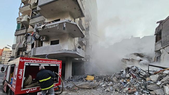 A firefighter battles a blaze at the site of an Israeli air strike that targeted the a suburb in Beirut’s southern suburbs. Picture: AFP