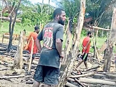 Locals at the scene in Tambari village following the attack. Picture: The National