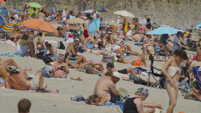 People gather on Gyllyngvase Beach in Falmouth, England as temperatures inch close to 40 degrees. Picture: Getty Images