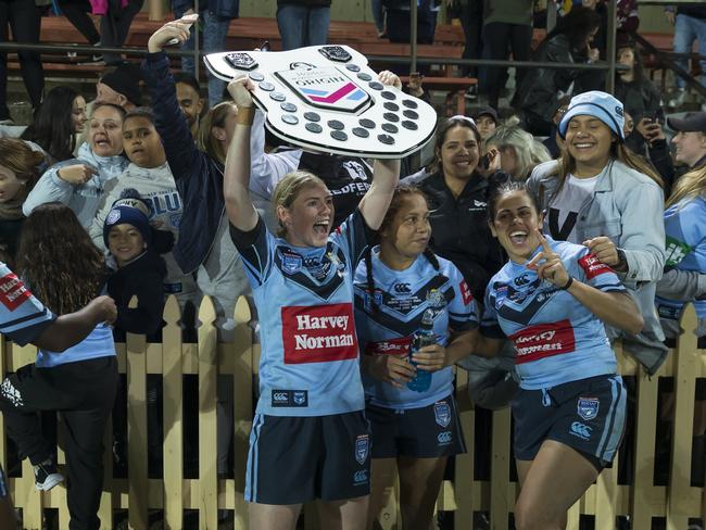 Maddison Studdon of the Blues holds the shield aloft after the Women's State of Origin match in 2018. Picture: AAP Image/Craig Golding