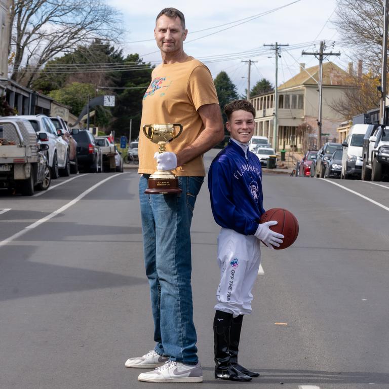 Basketballer Chris Anstey, left, and jockey Will Price, right, look all set to swap sporting codes on the main street of Trentham. Picture: Jay Town