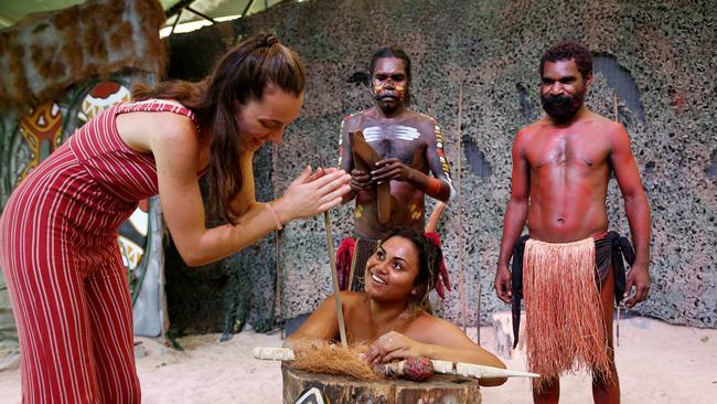 Vaida Bikeraite from Lithuania works a traditional fire stick under the watch of Warrick Newbury, Andrew Newbury and May Haeley from Tjapukai dance troop. PICTURE: STEWART MCLEAN