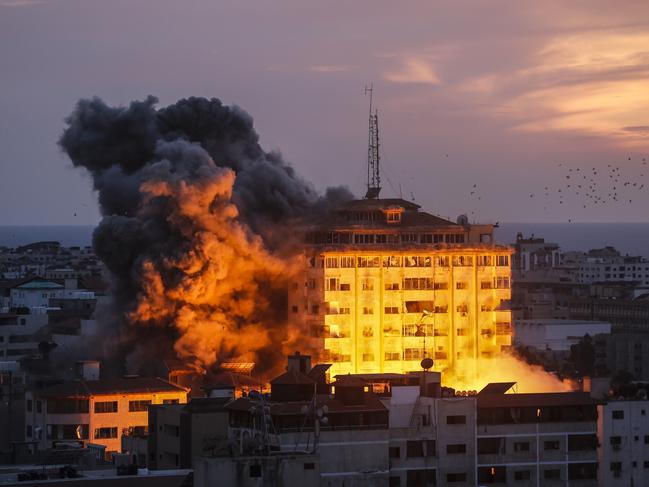 A smoke rises and ball of fire over a buildings in Gaza City on October 7, 2023 during an Israeli air strike. Medical sources in Gaza say at least 198 Palestinians have been killed in Israeli air attacks launched after a Hamas offensive against Israel that killed at least 70. (Photo by Sameh Rahmi/NurPhoto via Getty Images)