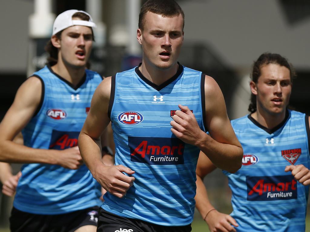 Draft pick eight Nik Cox (centre) could be about to make his debut for the Dons.