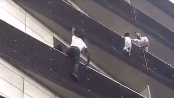 Mamoudou Gassama scaling the apartment building.