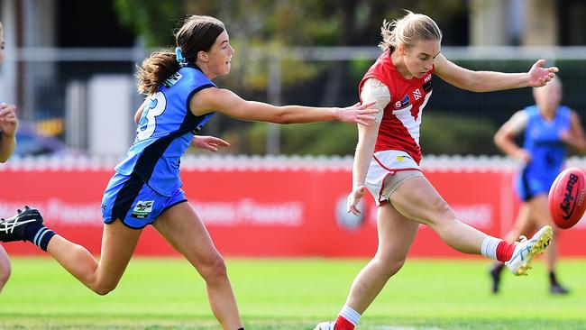 North Adelaide’s Erica Greet kick towards goal under pressure from Sturt’s Lucy Griffith in their SANFLW match at Peter Motley Oval on Saturday. Picture: AAP/Mark Brake