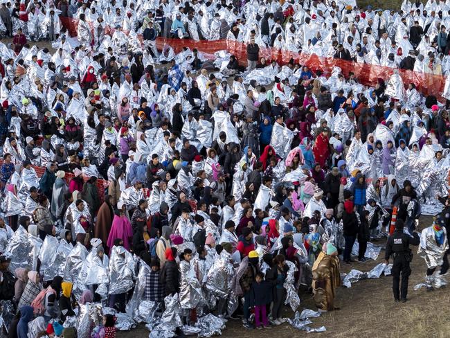 EAGLE PASS, TEXAS - DECEMBER 19: In an aerial view, thousands of immigrants, most wearing thermal blankets, await processing at a U.S. Border Patrol transit center on December 19, 2023 in Eagle Pass, Texas. Major surges of migrants illegally crossing the Rio Grande have overwhelmed U.S. border authorities in recent weeks. (Photo by John Moore/Getty Images)