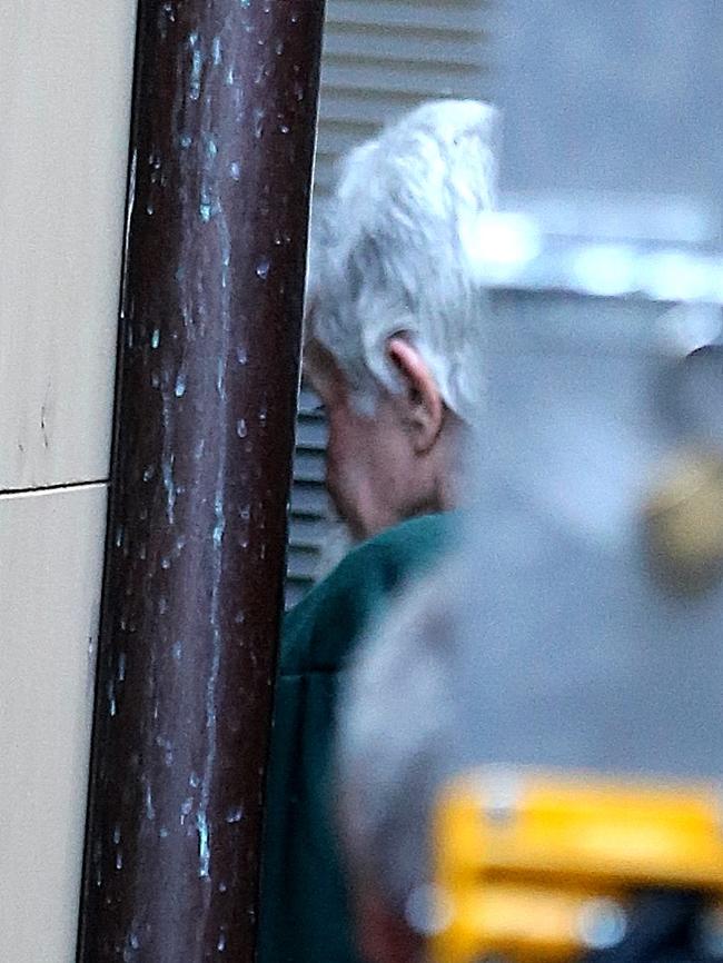 John Walsh being led into court for a sentencing hearing over a fourth murder while in jail. Picture: John Grainger