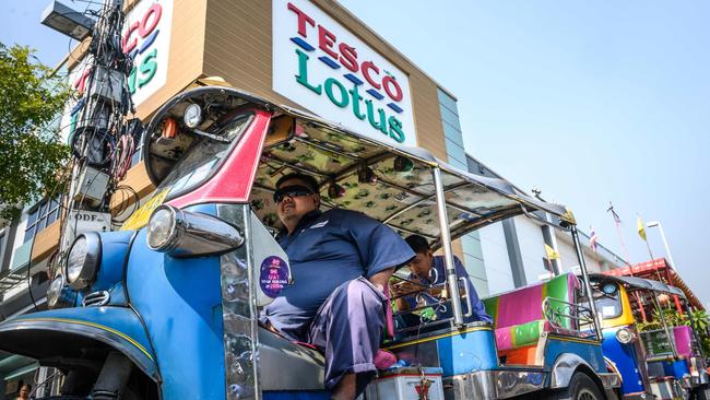 A tuktuk driver outside a Tesco Lotus supermarket, since rebranded as Lotus’s, Thailand’s largest hypermarket chain. Picture: AFP