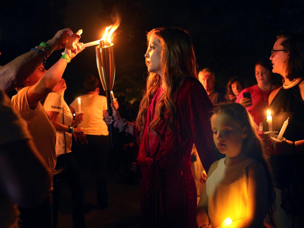 Lisa Marie lights the candles of some of the mourners who gathered to commemorate the 40th anniversary of the death of singer Elvis Presley at his former home of Graceland, in Memphis, Tennessee, in 2017. Picture: Reuters