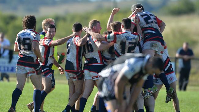 Camden rejoice over Chris Brown's match winning field goa l while defeat sinks in for Picton. Group six rugby league finals week 1 Camden Rams (white blue and red) v Picton (black and white) First grade qualification final at Camden