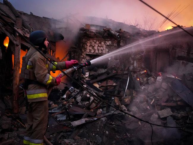 A Ukrainian rescuer works to extinguish a fire in a building following a drone attack in Mykolaiv. Picture: Ukrainian Emergency Service/AFP