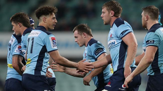 Tom Staniforth, second right, celebrates scoring a try for the Waratahs Picture: Getty Images