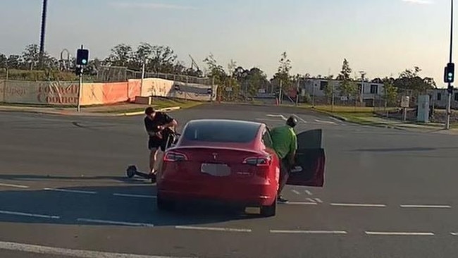 An e-scooter rider is thrown off his ride after smashing into a Tesla. Picture: dashcam Owners Australia