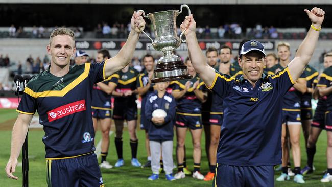Australian captain Joel Selwood and coach Alastair Clarkson celebrate victory in the International Rules Series in 2014.