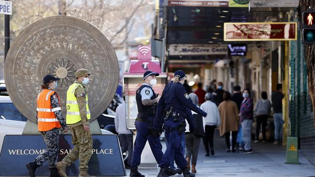 Police and Defence Force personnel patrolling the streets of Bankstown on Saturday. Picture: Tim Hunter