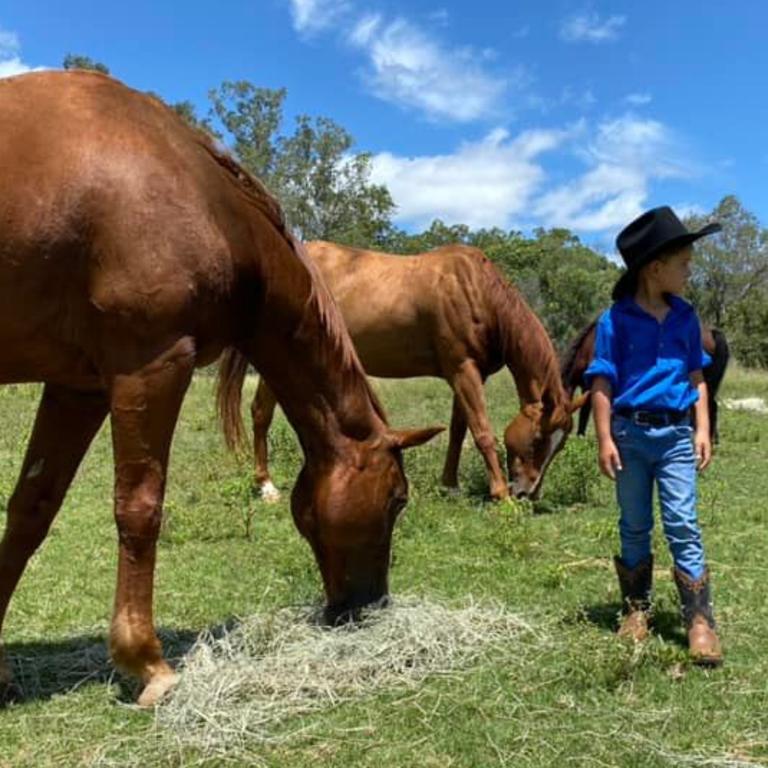 Kai Webber, 7, was treated with a new hat, boots, and a visit to the Dooboon property for his birthday where he formed a connection with the animals. Picture: Megan Webber