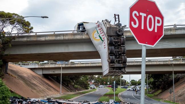 A Hazeldene's Chicken Farm truck hangs off the Calder Freeway over Arundel Rd in Keilor. Picture: Jake Nowakowski