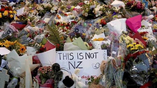 Mourners place flowers as they pay their respects at a makeshift memorial near the Masjid Al Noor mosque in Christchurch, New Zealand. Picture: Vincent Yu