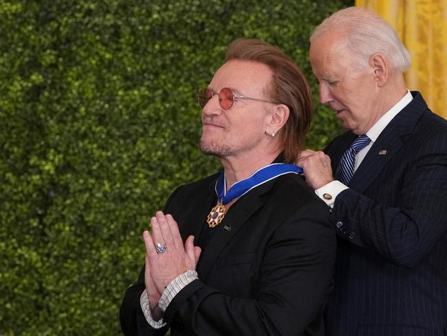 Bono appears to give thanks for his honour. Picture: AFP