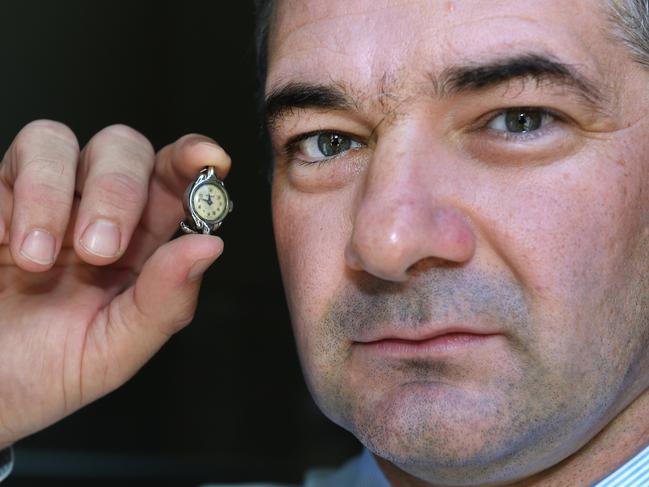 Detective Sergeant Nathan McIntosh with the watch. Picture: AAP image, John Gass