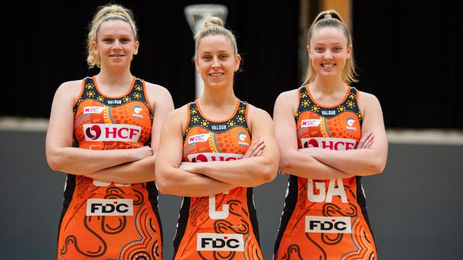 Giants players (l-r) Jo Harten, Jamie-Lee Price and Sophie Dwyer wearing the club's First Nations Round dress designed by Gamilaroi woman Krystal Dallinger.