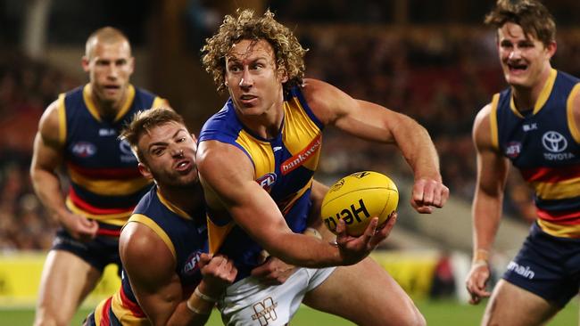 Matthew Priddis is tackled by Daniel Talia at Adelaide Oval.