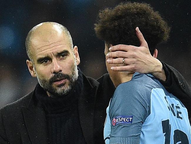 Manchester City's Spanish manager Pep Guardiola (L) consoles Manchester City's German midfielder Leroy Sane following the UEFA Champions League group C football match between Manchester City and Celtic at the Etihad Stadium in Manchester, northern England, on December 6, 2016. The match ended in a draw at 1-1. / AFP PHOTO / Oli SCARFF