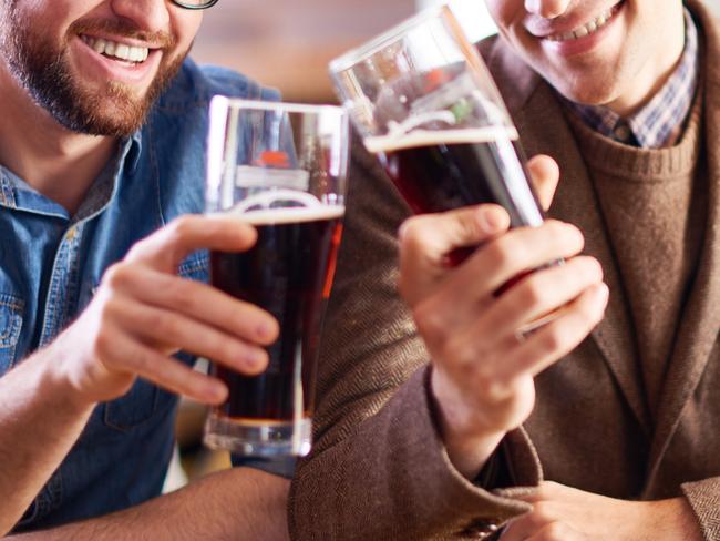 From istock, two friends hanging out together drinking dark beers. Source: Supplied