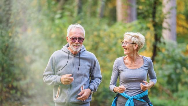 Smiling senior couple jogging in the park. Sports activities for elderly people. Active seniors generic