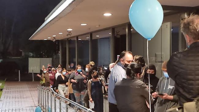 Eager patrons queue outside Toongabbie Sports Club just ahead of midnight.