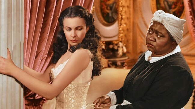 Scarlett (Vivien Leigh) being laced into a corset by Mammy (Hattie McDaniel) in Gone with the Wind.